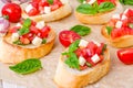 Bruschetta with tomato, onion, cheese and fresh basil Royalty Free Stock Photo