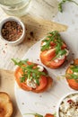 Bruschetta with tomatoes, arugula, olive oil and cheese on plate on textured background close up. Fresh italian toasts