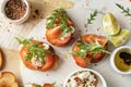 Bruschetta with tomatoes, arugula, olive oil and cheese on plate on textured background. Fresh italian toasts top view