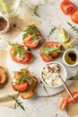 Bruschetta with tomatoes, arugula, olive oil and cheese on plate on textured background. Fresh italian toasts top view