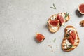 Bruschettas with ripe figs and on light table, flat lay. Space for text