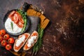 Bruschettas with stracciatella cheese, chopped cherry tomatoes and rosemary. Dark background. Top view. Copy space Royalty Free Stock Photo