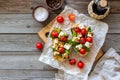 Bruschettas with tomatoes and cheese. Italian cuisine. Rustic style. Vegetarian food Royalty Free Stock Photo