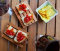 Bruschettas topped with olive oil, garlic and tomatoes