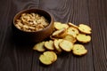 Bruschette chips  roasted peanuts in a bowl  salty beer snacks on wooden background Royalty Free Stock Photo