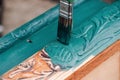 brush with blue or green paint macro painting old wooden furniture for reuse, eco-friendly lifestyle