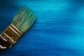 A brush on a blue nacreous color painted background.