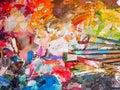 Brush and bright oil-paint palette for background Royalty Free Stock Photo