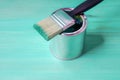 Brush with green paint loves on a paint can Royalty Free Stock Photo