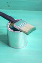 Brush with green paint loves on a paint can Royalty Free Stock Photo