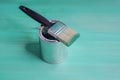 Brush with green paint loves on a paint can Royalty Free Stock Photo