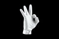 Brush, Hand in a white glove isolated on a black background, shows the gesture ok. Human gesture concept of approval, cool Royalty Free Stock Photo