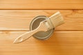 Brush with a jar of paint on a background of natural wooden boards Royalty Free Stock Photo