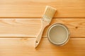 Brush with a jar of paint on a background of natural wooden boards Royalty Free Stock Photo