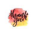 Brush lettering Thank you on watercolor splash in red and yellow colors