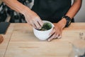 A brush made of bamboo and a teacup with green tea called matcha on wooden tray made by professional barista in Asian cafe. Royalty Free Stock Photo