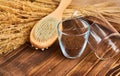 Brush massage counter, washcloth for shower with double nozzles with bunch of dried straw and natural coffee scrub in glass, towel