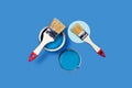 Brush and pain can on a blue background. Royalty Free Stock Photo