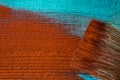 Brush with paint in hand. A man paints blue boards in a brown paint brush. Royalty Free Stock Photo