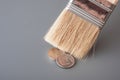 Brush for painting sweep metal money on a gray surface