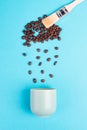 Brush paints cloud with roasted coffee beans raining into a cup, take a break, having an espresso for breakfast in the morning Royalty Free Stock Photo