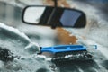 The brush removes snow from the car. Removing frost from the windshield Royalty Free Stock Photo