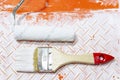 Brush and roller in used paint tray, apartment repair, painting and design concept. Royalty Free Stock Photo