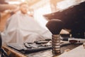 Brush for shaving beard along with bowl, blurred background of hair salon for men, barber shop Royalty Free Stock Photo