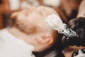 Brush for shaving beard along with bowl, blurred background of hair salon for men, barber shop Royalty Free Stock Photo