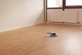 Brush with a shovel lying on the floor in the middle of an empty bright room