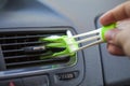 A brush to remove dust in the vents from the air conditioner car, male hand with a brush for wiping dust on the dashboard of the Royalty Free Stock Photo