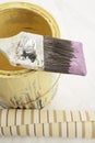 Brush to side on paint can