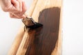 brush varnishing a wooden doorway closeup, door restoration