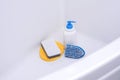 Brush, washcloth and rubber gloves in white bath Royalty Free Stock Photo