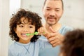 Brush your teeth everyday, To keep dentist away. a father teaching his son how to brush teeth at home. Royalty Free Stock Photo