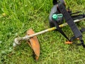 Brushcutter lies on a meadow for mowing Royalty Free Stock Photo