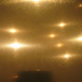 Brushed brass surface with a reflective texture, featuring streaks and circular patterns. The Royalty Free Stock Photo