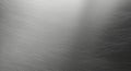 Brushed metal surface with fine horizontal grains and a subtle gradient from light to dark. The Royalty Free Stock Photo