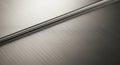 Brushed metal surface with parallel grooves creating a linear pattern. The metallic texture Royalty Free Stock Photo