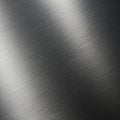 Brushed metal surface with a smooth texture and linear patterns running diagonally Royalty Free Stock Photo