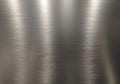 Brushed metal surface with a smooth texture showing parallel, linear patterns. The metallic color Royalty Free Stock Photo