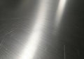Brushed metal surface with a uniform pattern of fine parallel lines creating a matte finish. The Royalty Free Stock Photo