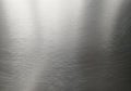 Brushed metal texture with a smooth, matte finish. Fine linear patterns run uniformly, creating a Royalty Free Stock Photo