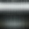 Brushed metal texture with vertical lines creating a sleek, polished appearance. The Royalty Free Stock Photo