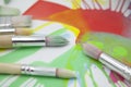 Brushes and abstract paints on white background