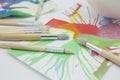 Brushes and abstract paints on white background