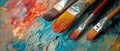 Brushes Arranged on Vibrant Colorful Artistic Background for Creative Expression. Royalty Free Stock Photo
