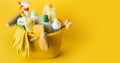 Brushes, bottles with cleaning liquids, sponges, rag and yellow rubber gloves on the yellow background. Cleaning supplies in the Royalty Free Stock Photo