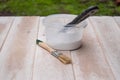 Brushes and cans with white paint on the boards. Preparation for painting boards Royalty Free Stock Photo