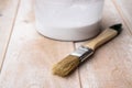 Brushes and cans with white paint on the boards. Preparation for painting boards Royalty Free Stock Photo